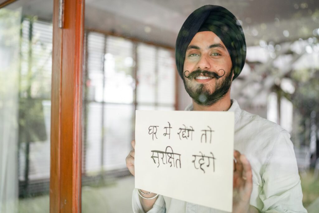 content indian guy showing paper with hindi inscription